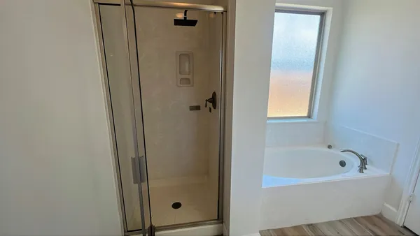 a bathroom with a bathtub and shower