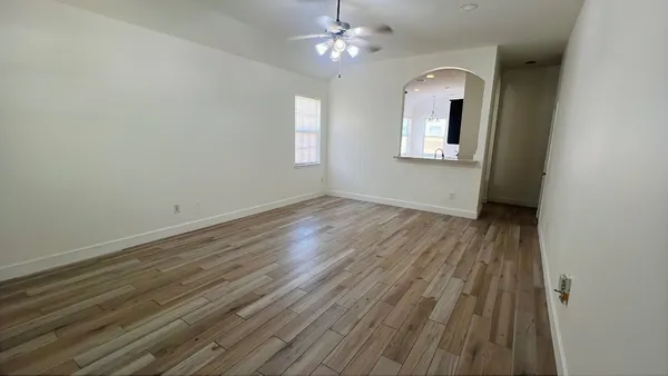 wooden floor in an empty room with a window