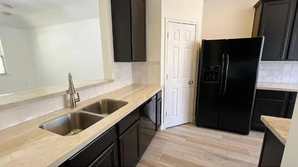 a kitchen with a sink and refrigerator