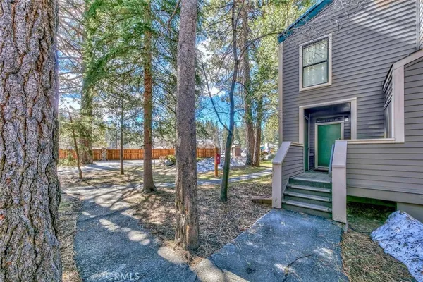 a view of a house with a tree in the yard