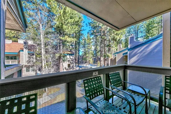 a view of a chairs and table in the balcony