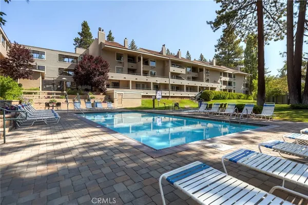 a swimming pool with outdoor seating and yard