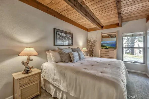 a bedroom with bed and a large window