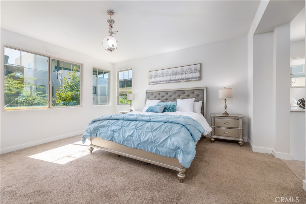 126 Interval Irvine, CA 92618 - Photo 15 of 47 a bedroom with a bed and large windows