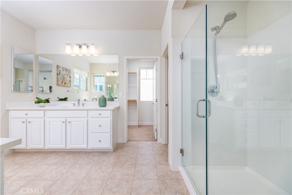 126 Interval Irvine, CA 92618 - Photo 19 of 47 a spacious bathroom with a double vanity sink shower and mirror