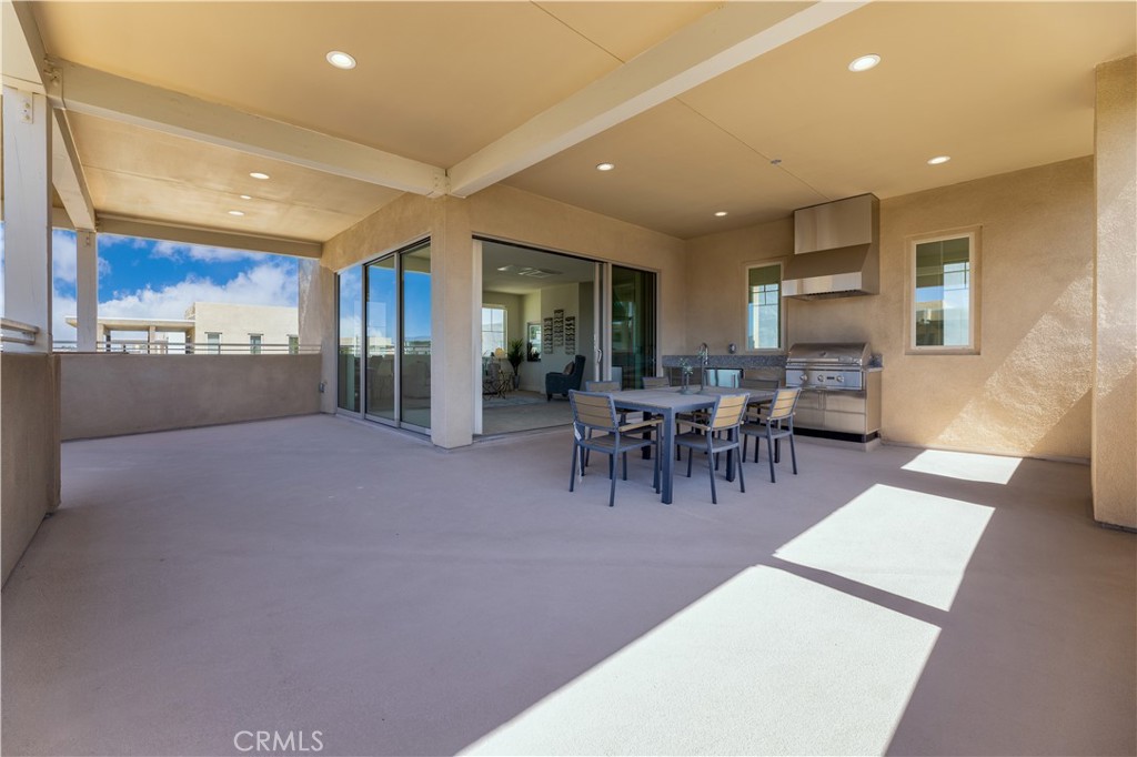 126 Interval Irvine, CA 92618 - Photo 30 of 47 a view of a patio with dining table and chairs