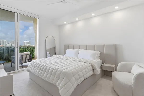 an outdoor space with patio lots of white furniture and rug