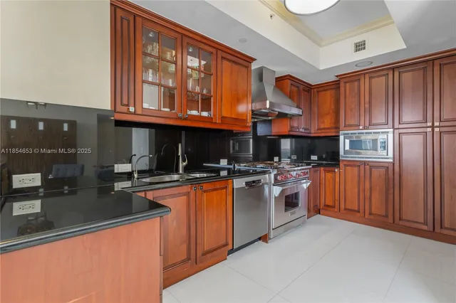 a kitchen with stainless steel appliances granite countertop a stove and a sink