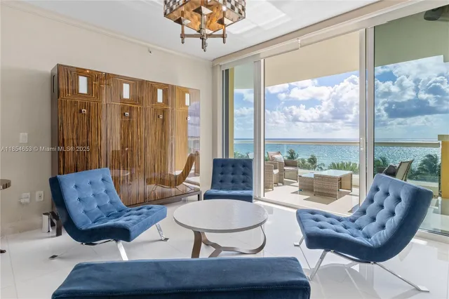 a living room with furniture and a floor to ceiling window