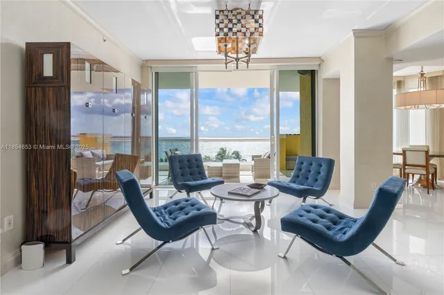 a view of a dining room with furniture a chandelier and wooden floor