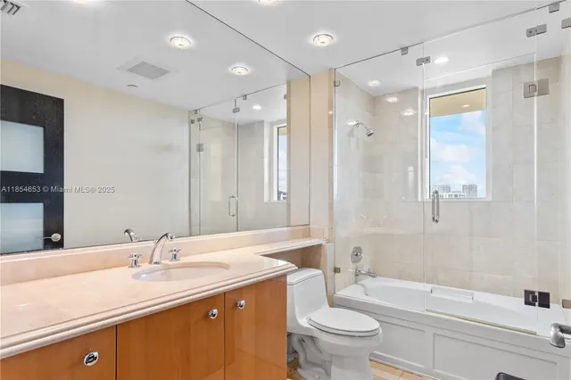 a bedroom with a large bed and a large window