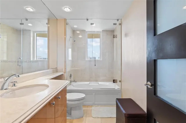 a bedroom with a bed and flat screen tv