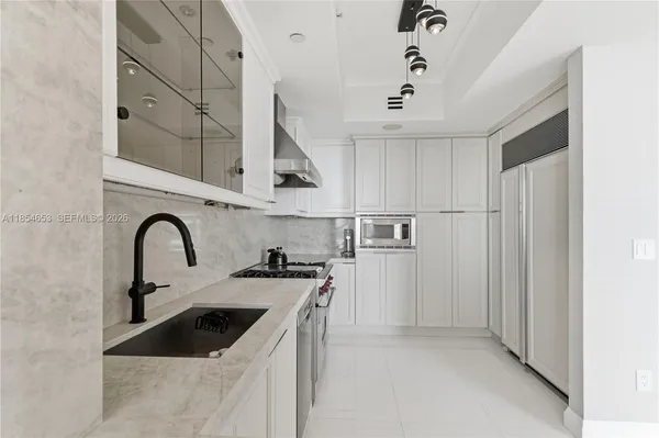 a bedroom with a bed a large window and walk in closet