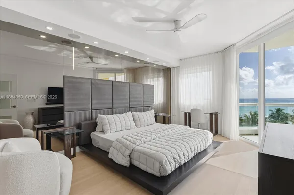 a large bedroom with a bed and a large window