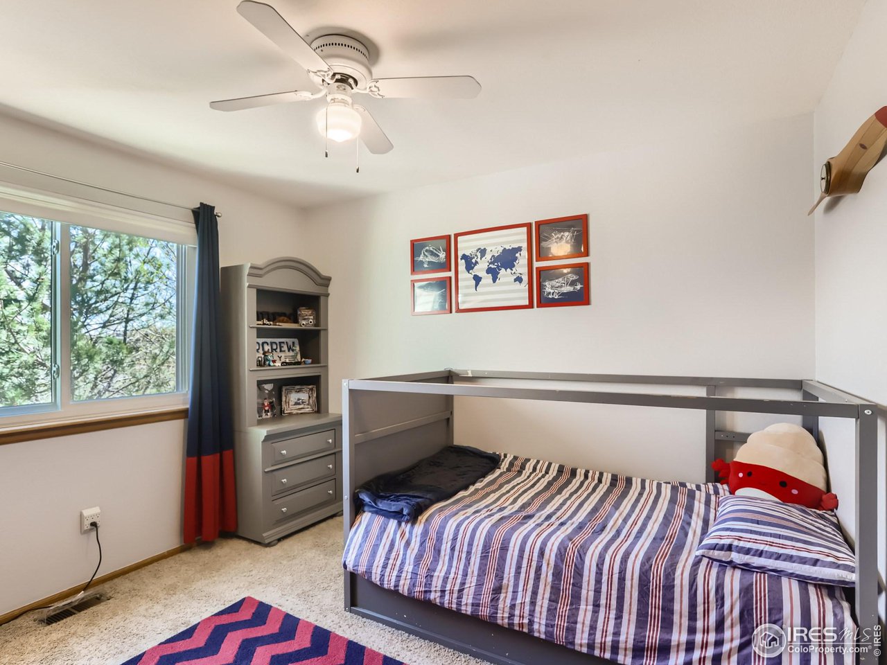 1752 Eldorado Drive Superior, CO 80027 - Photo 21 of 34 a bedroom with a bed and a chandelier