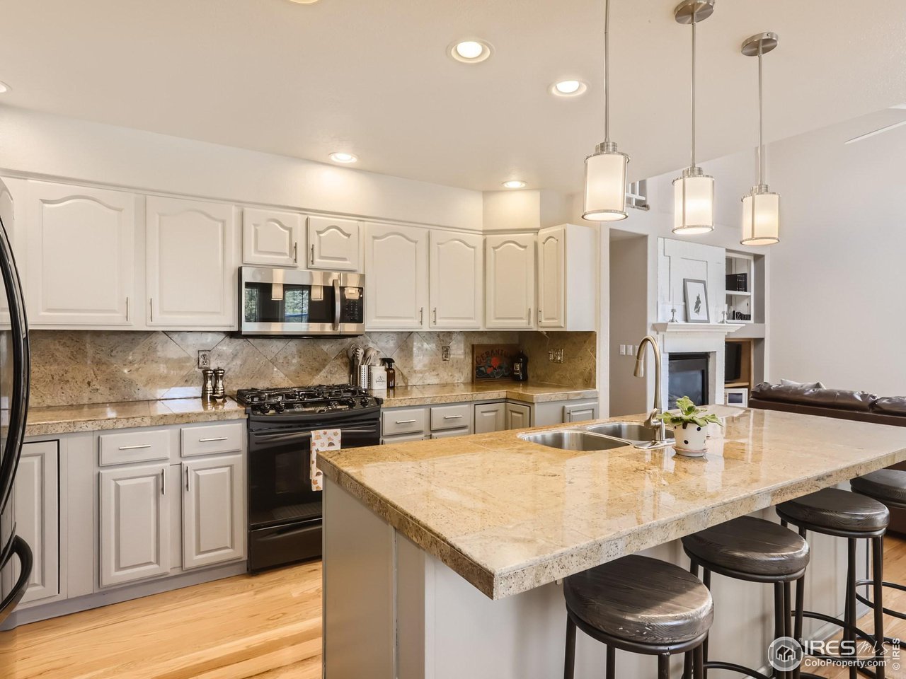 1752 Eldorado Drive Superior, CO 80027 - Photo 9 of 34 a large kitchen with granite countertop a stove a sink a center island and cabinets
