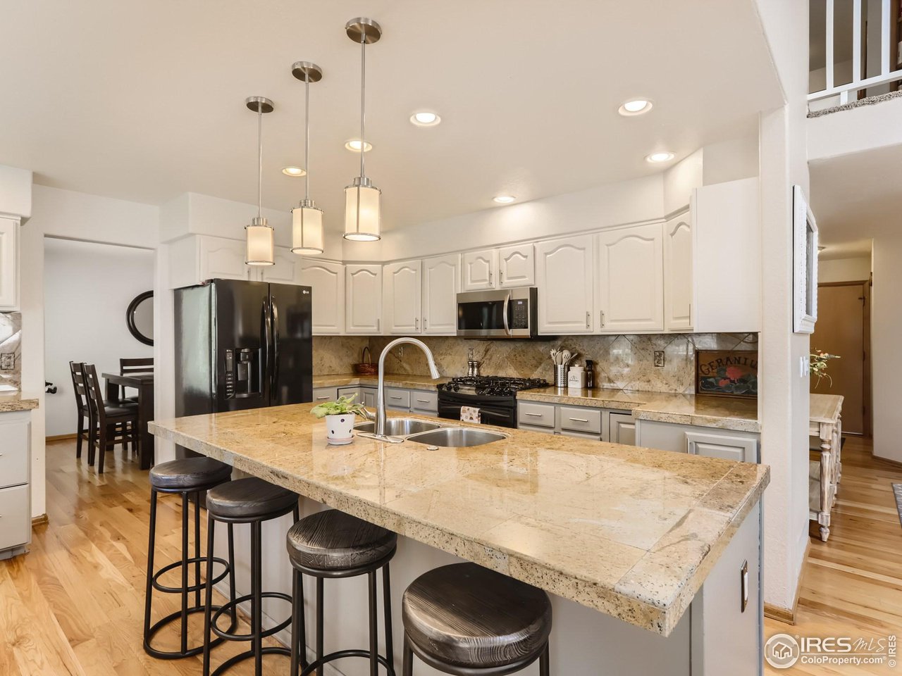 1752 Eldorado Drive Superior, CO 80027 - Photo 10 of 34 a kitchen with stainless steel appliances granite countertop a kitchen island a stove a table and chairs