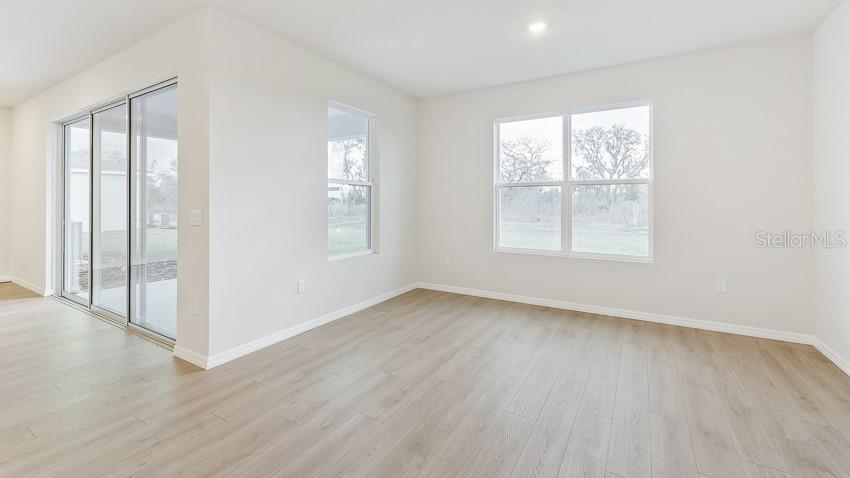 1925 Cobb Trail Parrish, FL 34219 - Photo 6 of 25 an empty room with wooden floor and windows