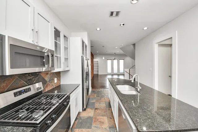 a kitchen with a stove a sink and a microwave