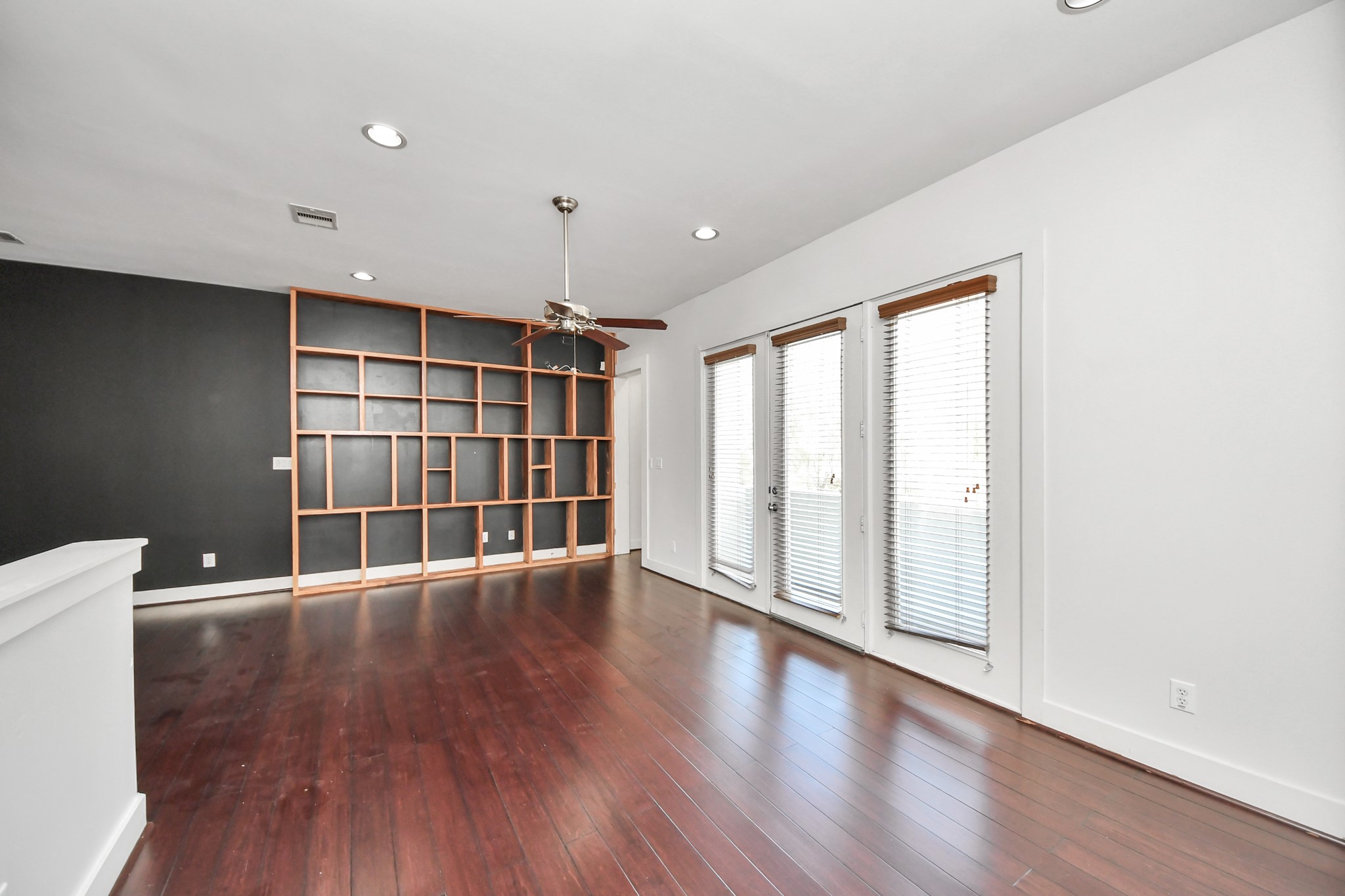 2911 Chartres Street Houston, TX 77004 - Photo 15 of 37 a view of an empty room with a window and wooden floor