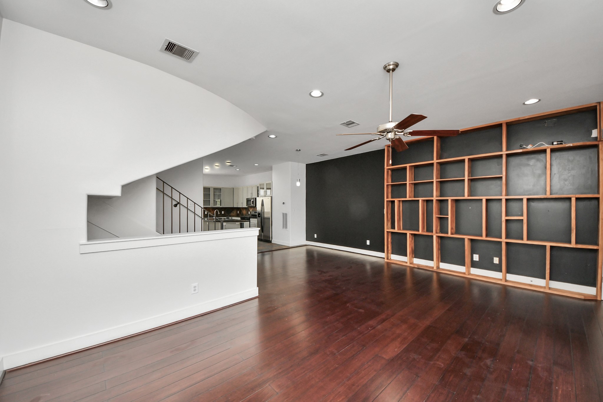 2911 Chartres Street Houston, TX 77004 - Photo 16 of 37 a view of empty room with wooden floor and windows