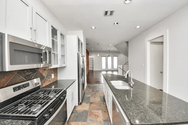 a kitchen with a sink and chandelier