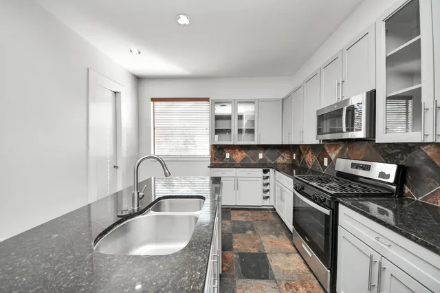 a kitchen with a sink and chandelier