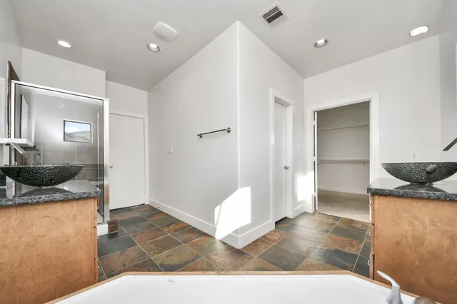 a view of a bedroom with closet and windows