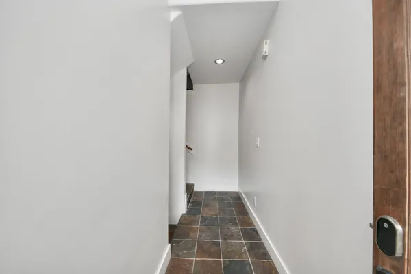 an empty room with windows and ceiling fan