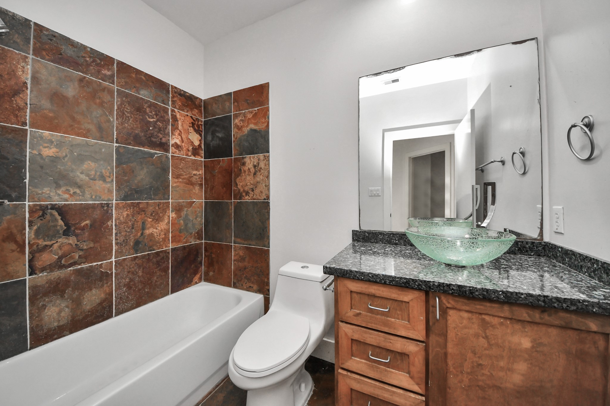 2911 Chartres Street Houston, TX 77004 - Photo 5 of 37 a bathroom with a granite countertop sink toilet and shower