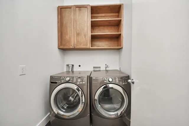a utility room with sink dryer and washer