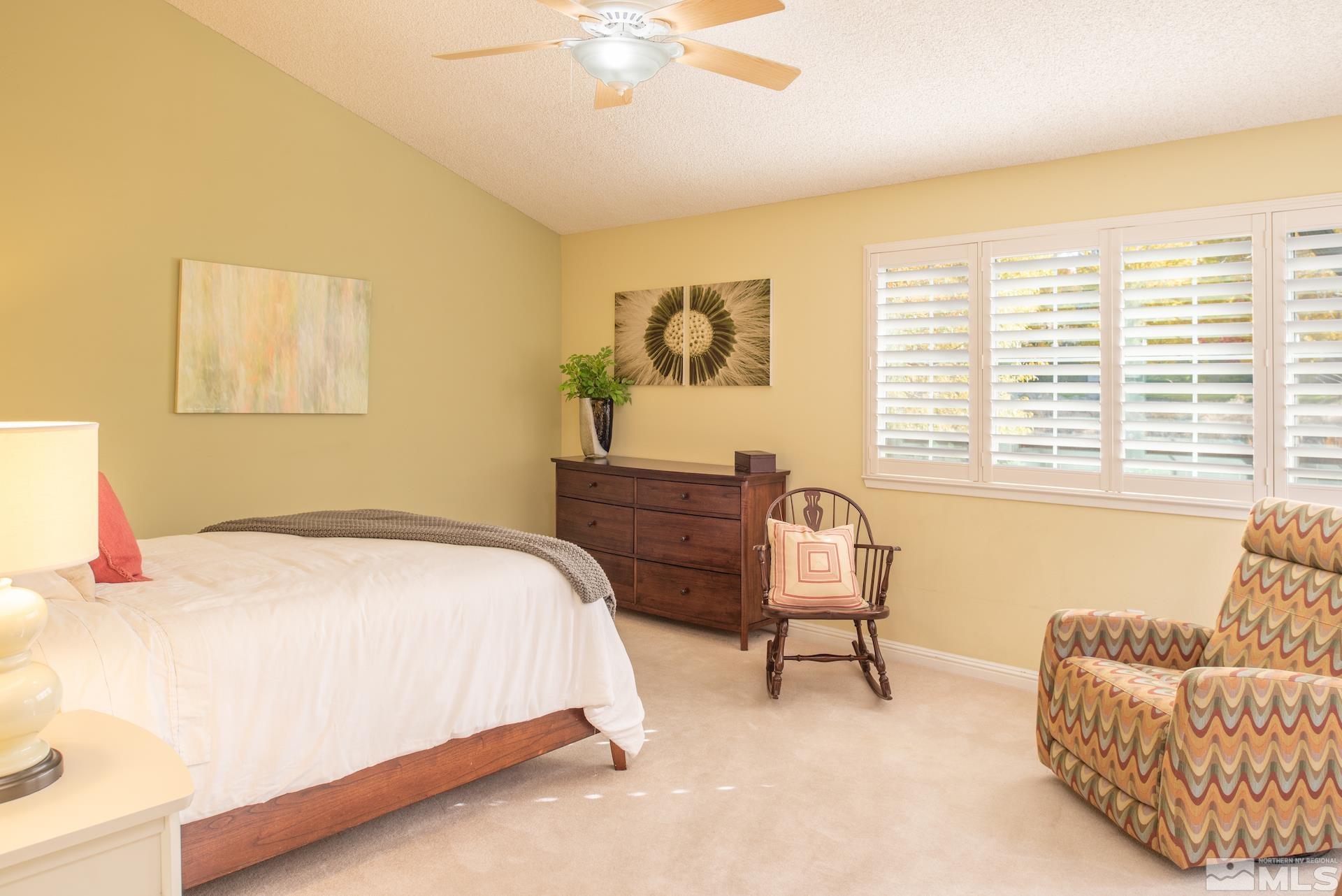 6328 Windy Meadow Drive Reno, NV 89519 - Photo 11 of 35 a bedroom with a bed and a couch