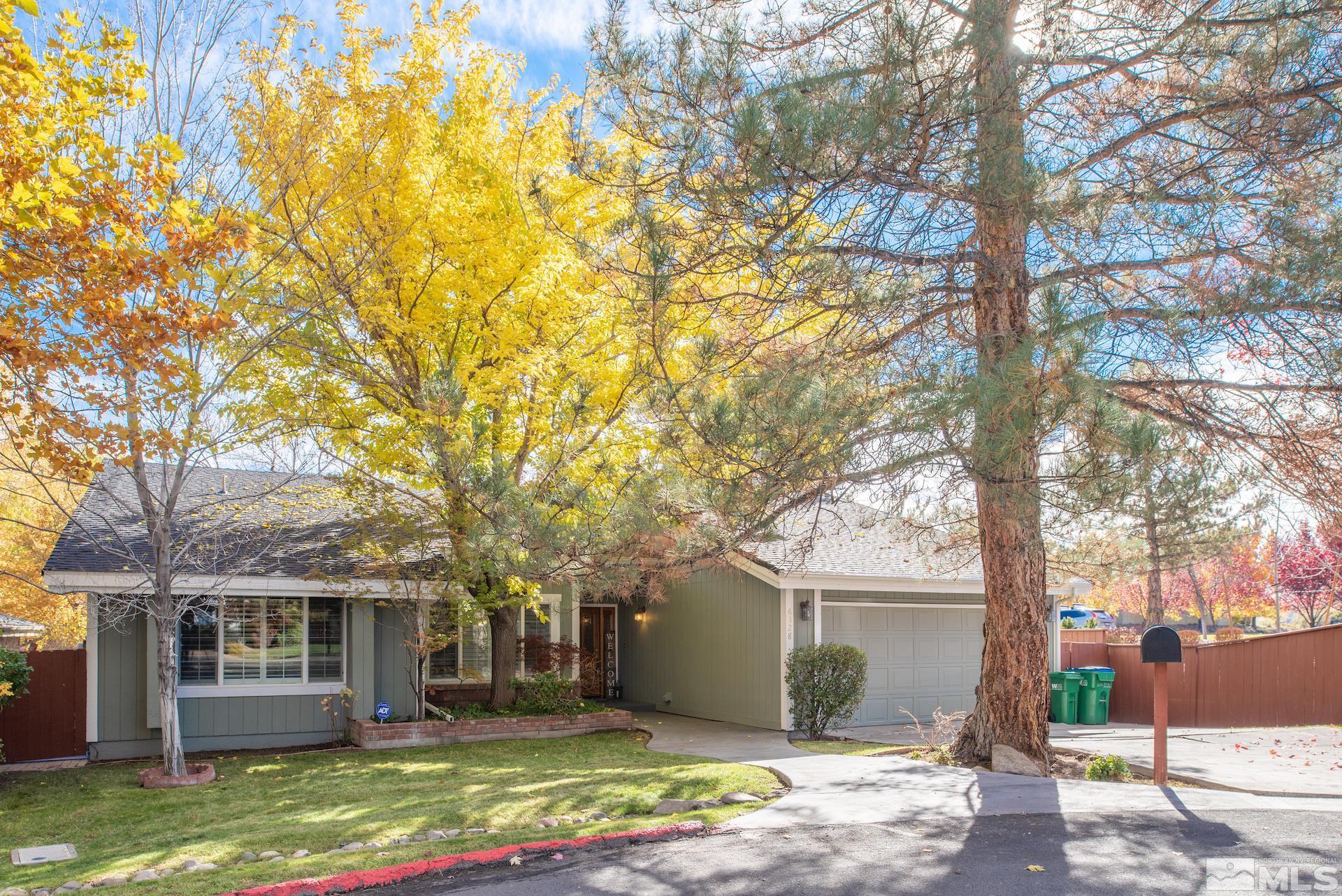 6328 Windy Meadow Drive Reno, NV 89519 - Photo 31 of 35 a front view of a house with a yard garage and outdoor seating
