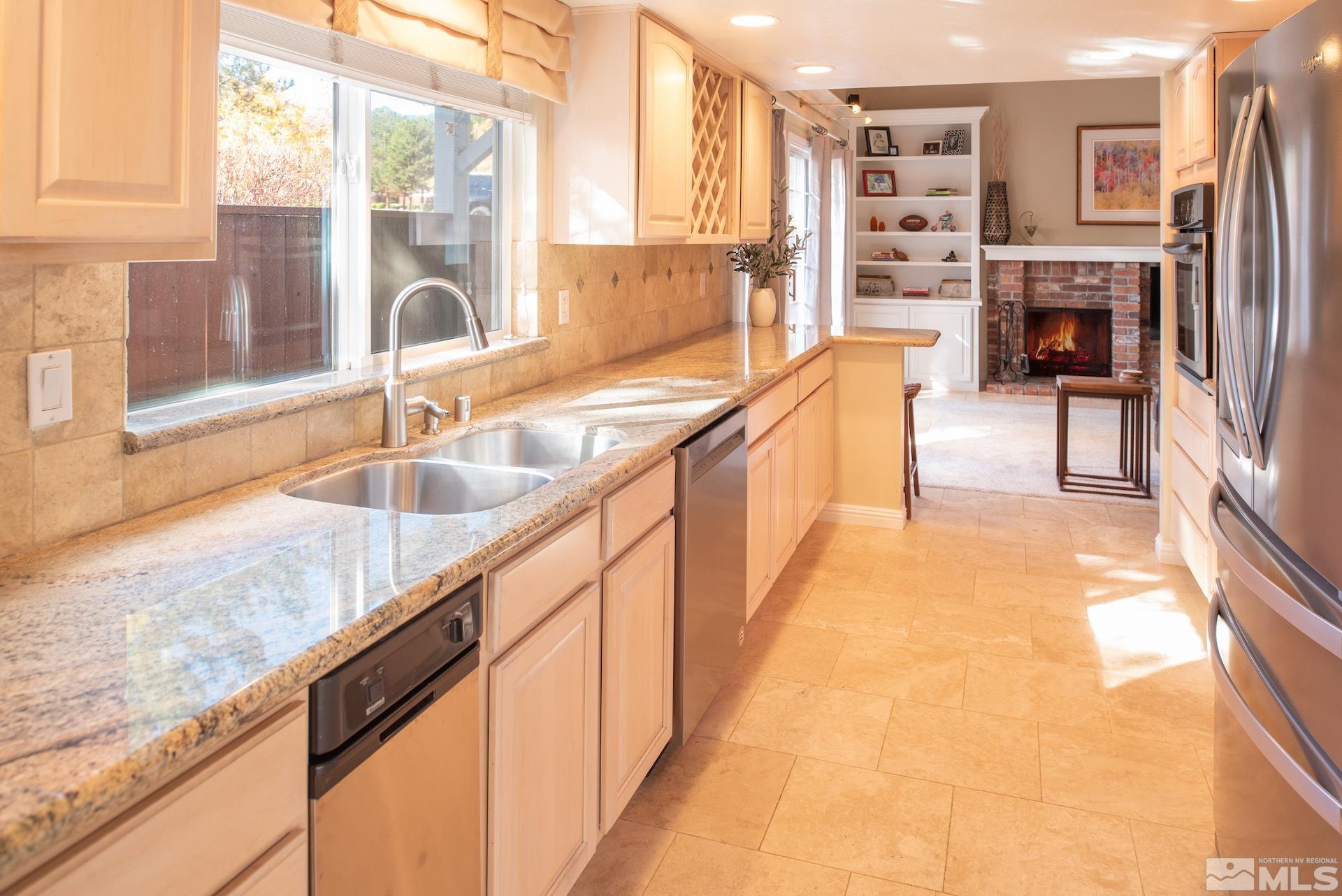 6328 Windy Meadow Drive Reno, NV 89519 - Photo 9 of 35 a view of kitchen with granite countertop a sink and a counter top space
