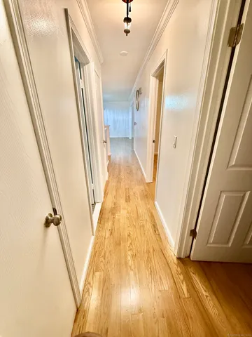 a view of hallway with wooden floor