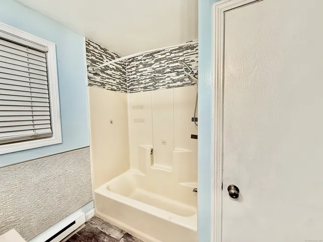 a bathroom with a bathtub and a shower