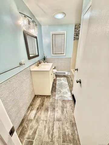 a bathroom with a sink mirror vanity and bathtub