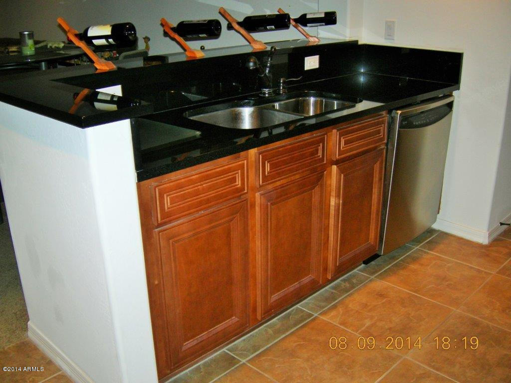 3935 East Rough Rider Road, Unit 1003 Phoenix, AZ 85050 - Photo 18 of 53 Kitchen overlooks Great Room & Dining