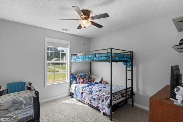 a bedroom with a bed and a tv