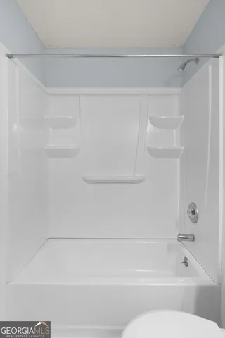 a bathroom with a shower and a bath tub