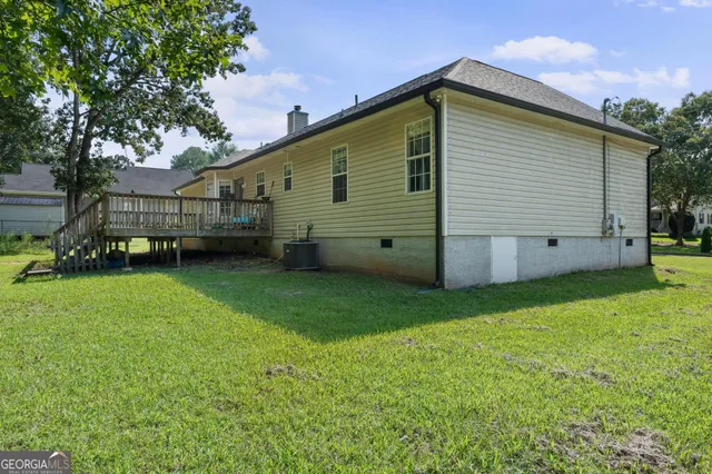 a view of a backyard with potted plants and large tree