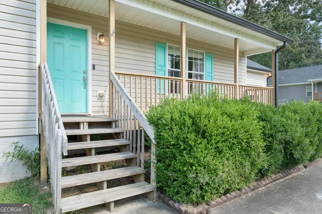 a view of a house with backyard and deck