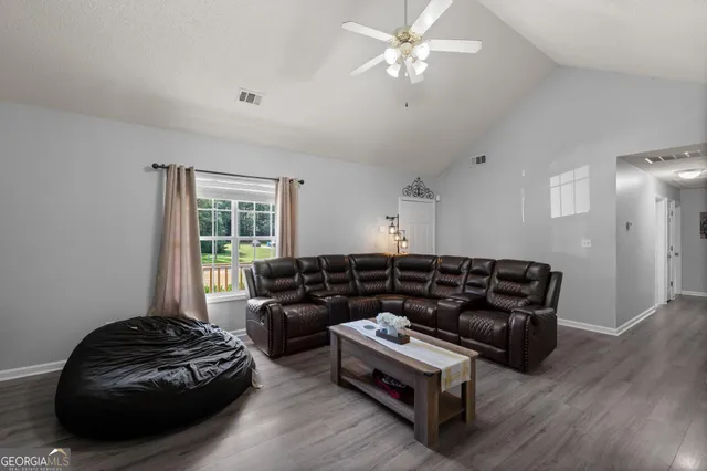 a living room with furniture and a window