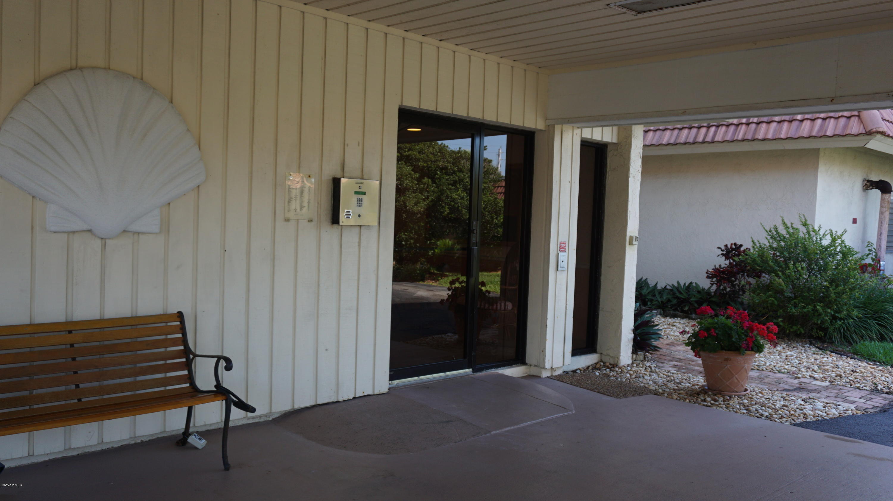 1095 Highway A1a Indialantic, Unit 204 Indialantic, FL 32903 - Photo 13 of 18 a potted plant sitting in front of a house