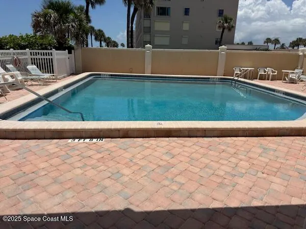 a view of swimming pool from a balcony