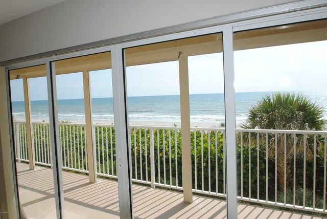 a view of a balcony with wooden floor