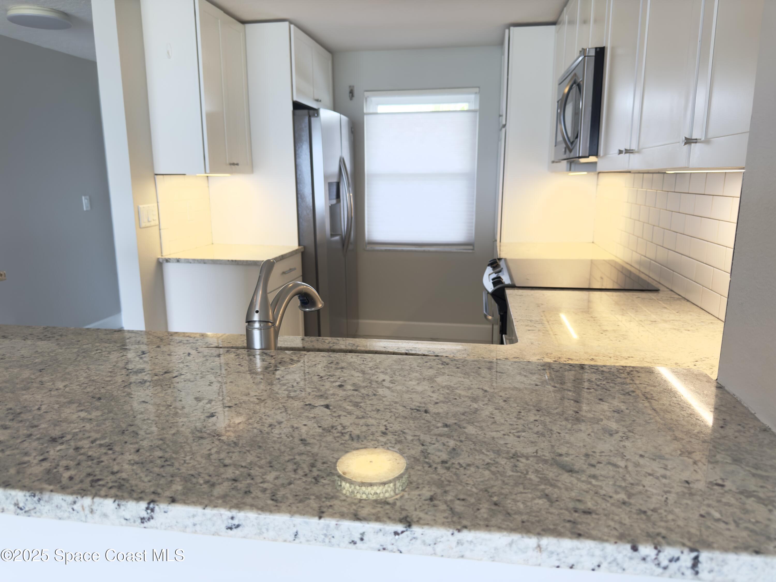 1095 Highway A1a Indialantic, Unit 204 Indialantic, FL 32903 - Photo 7 of 18 a bathroom with a sink a vanity and a mirror