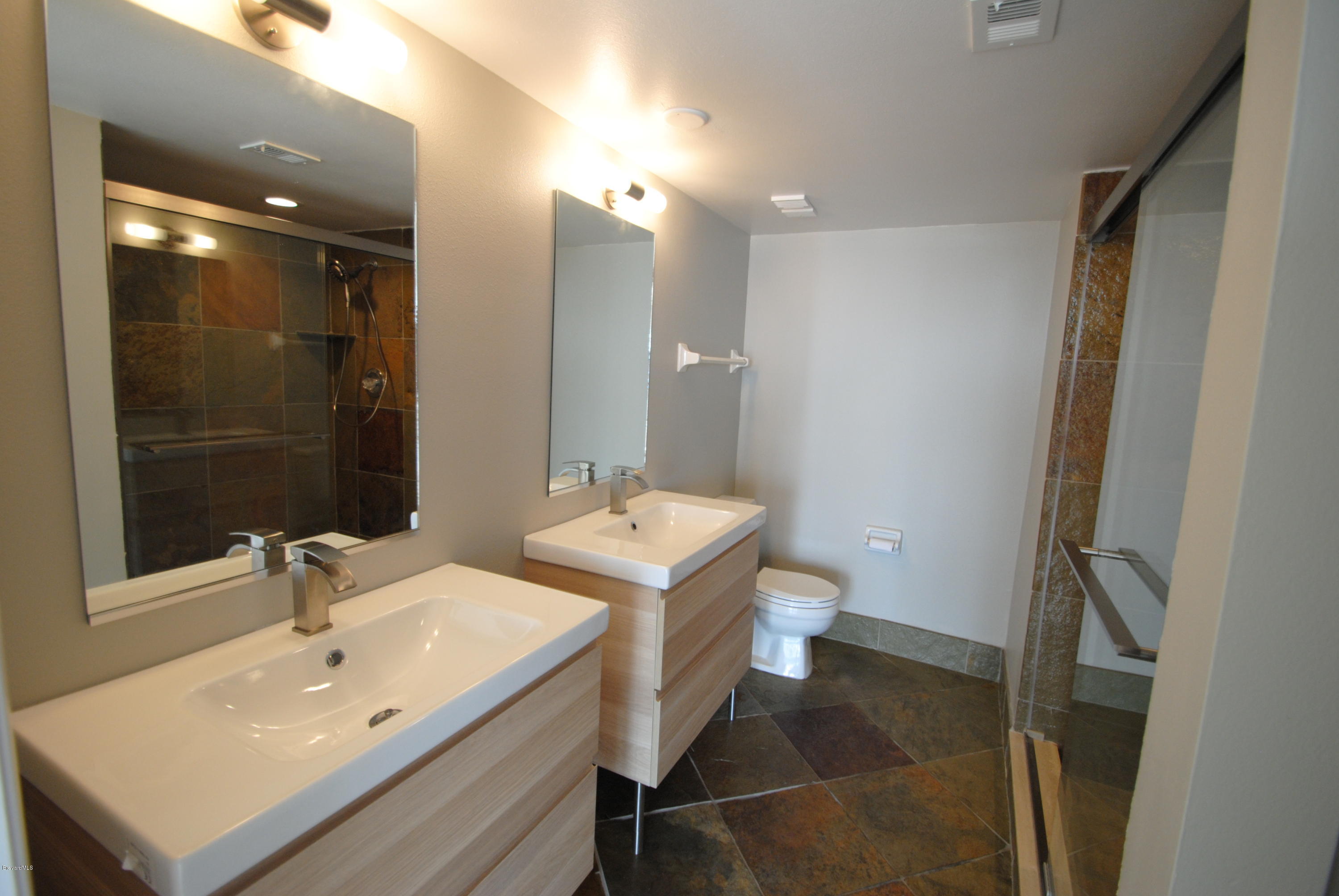 1095 Highway A1a Indialantic, Unit 204 Indialantic, FL 32903 - Photo 9 of 18 a bathroom with a sink toilet and shower