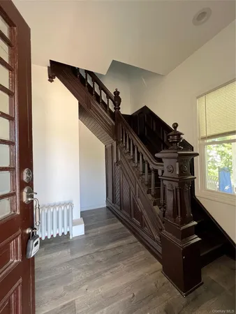 a view of entryway and hall with wooden floor