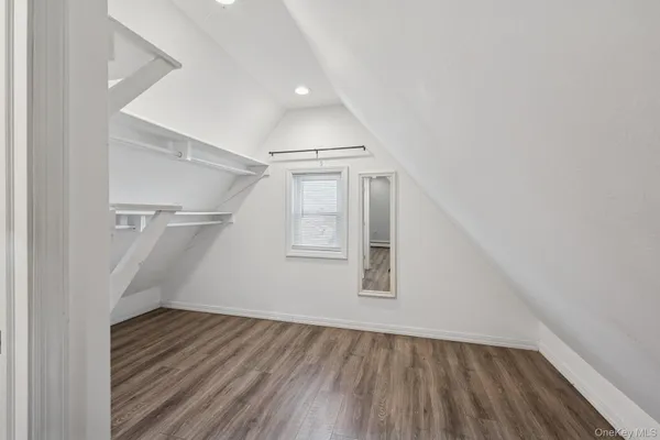 an empty room with wooden floor and door